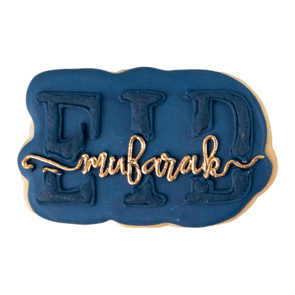 Eid Mubarak butter cookie with navy icing and gold lettering.
