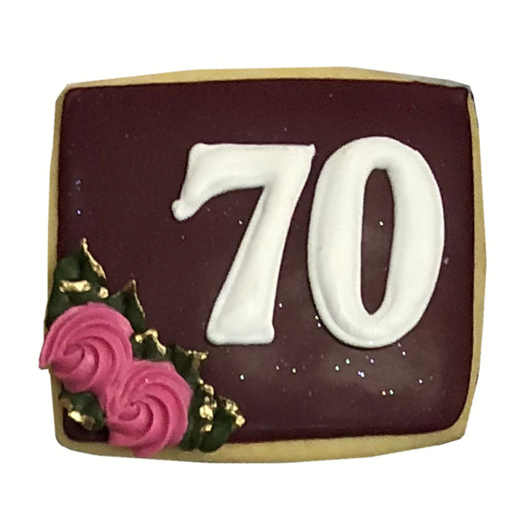 70th age plaque with maroon icing and pink rose accents.