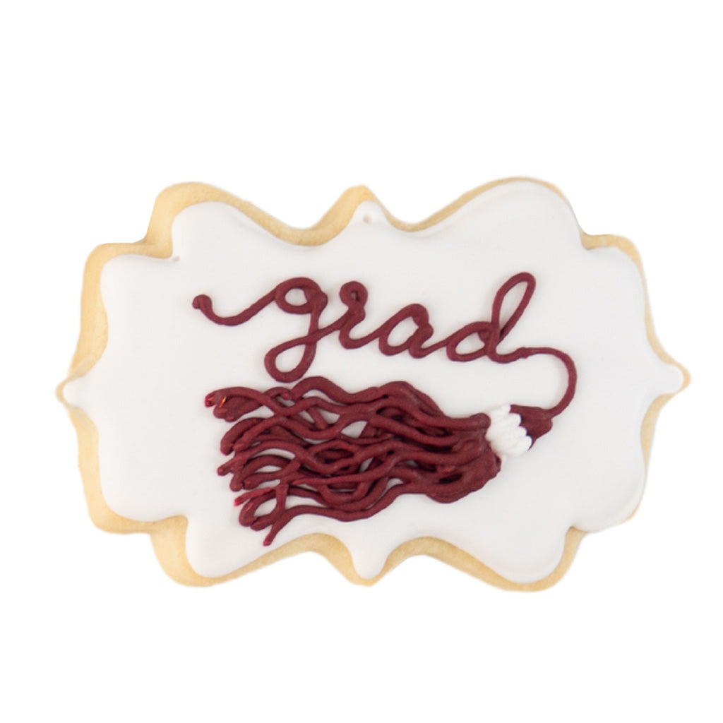 Graduation tassel cookie with white icing and maroon script.
