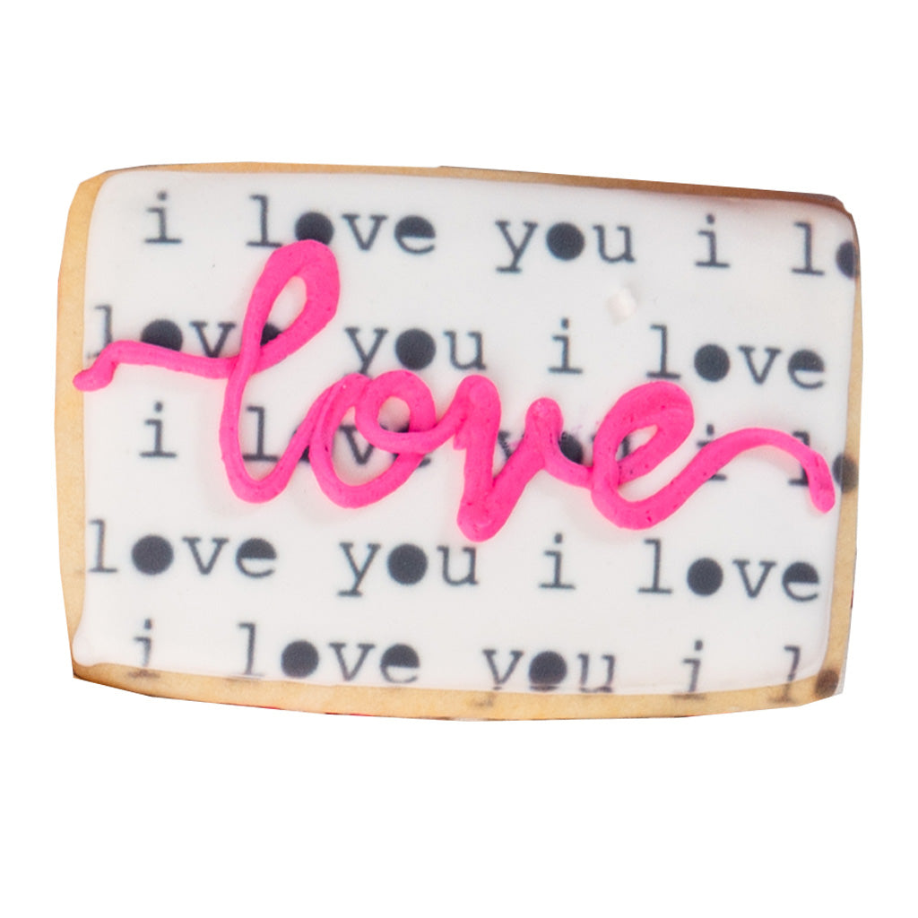 Valentine butter cookie with white icing and pink love script.
