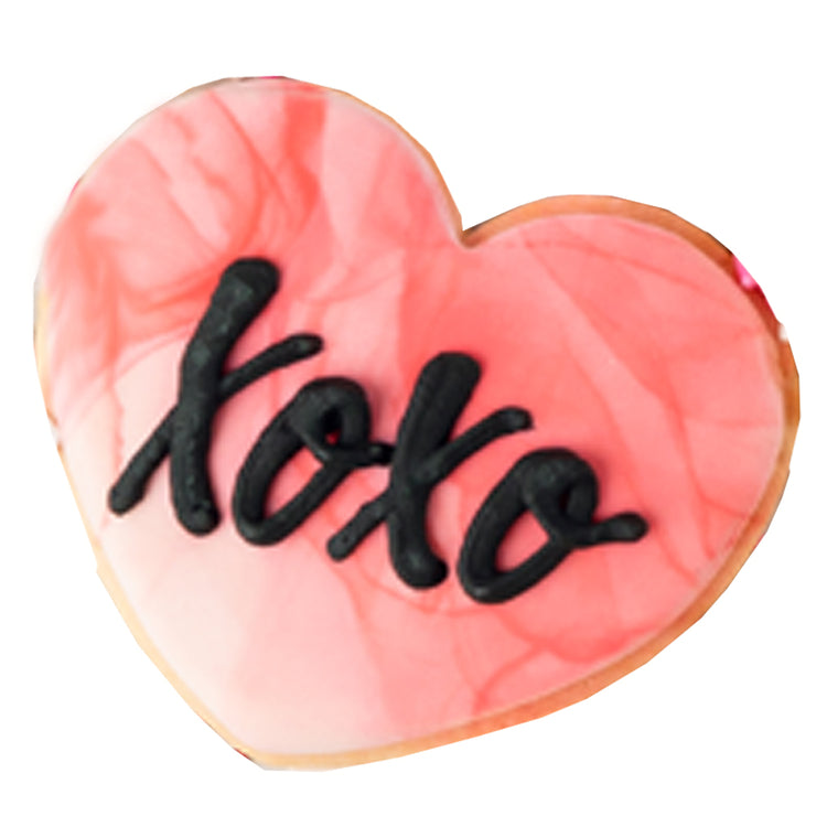 Heart-shaped Valentine butter cookie with black XOXO icing.