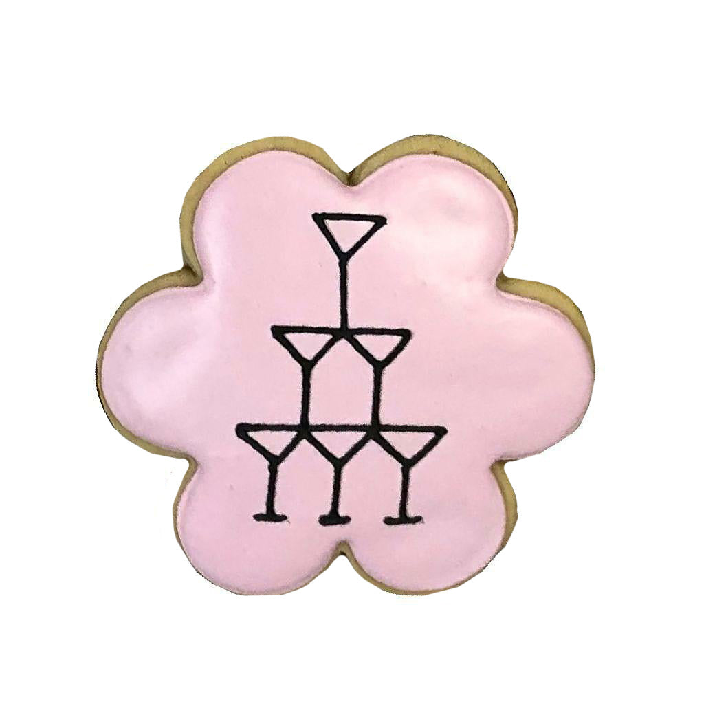 Martini glass tower on a pink flower-shaped cookie.