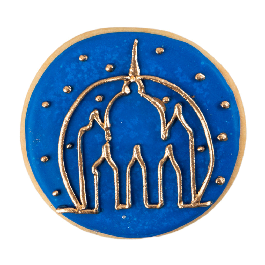 Round butter cookie with blue icing and gold mosque design.