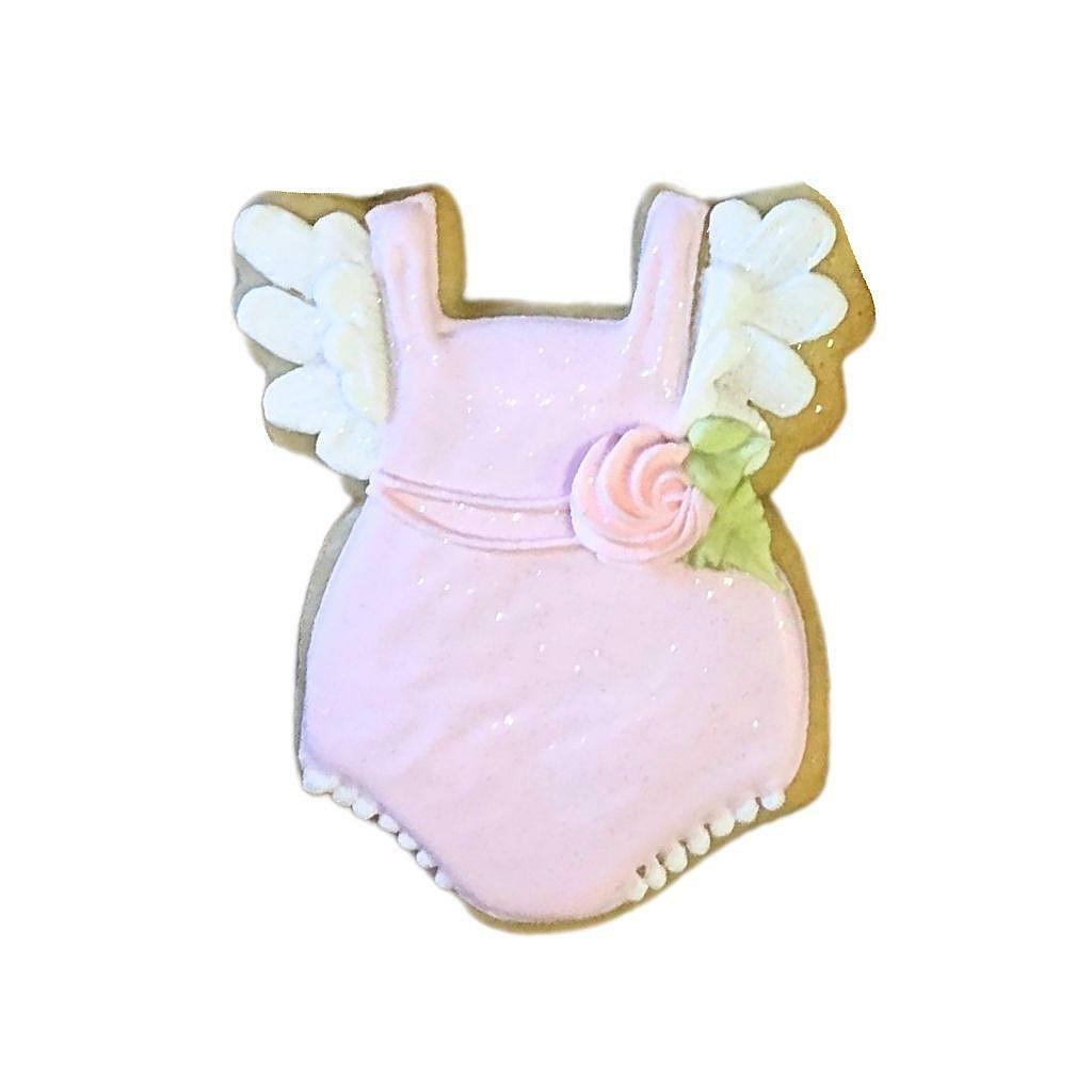 Baby Girl #2 cookie shaped like a pink onesie with wings.