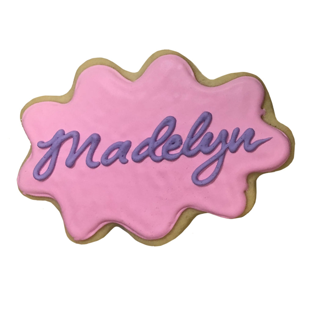 Princess name plaque cookie with pink icing and purple lettering.