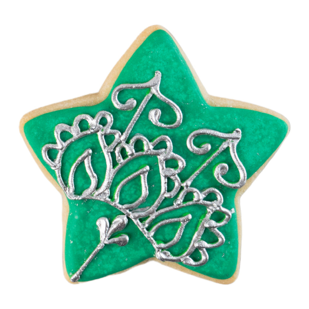 Star-shaped Ramadan butter cookie with green icing and silver detail