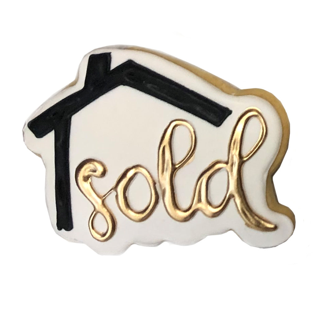 SOLD house sign cookie with black roof and gold lettering.