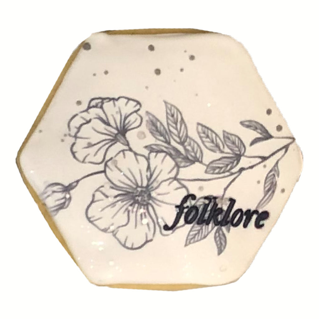 Taylor Swift Folklore hexagon cookie with floral icing design.