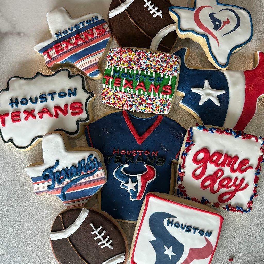 Assorted Houston Texans cookies with team logos and footballs.