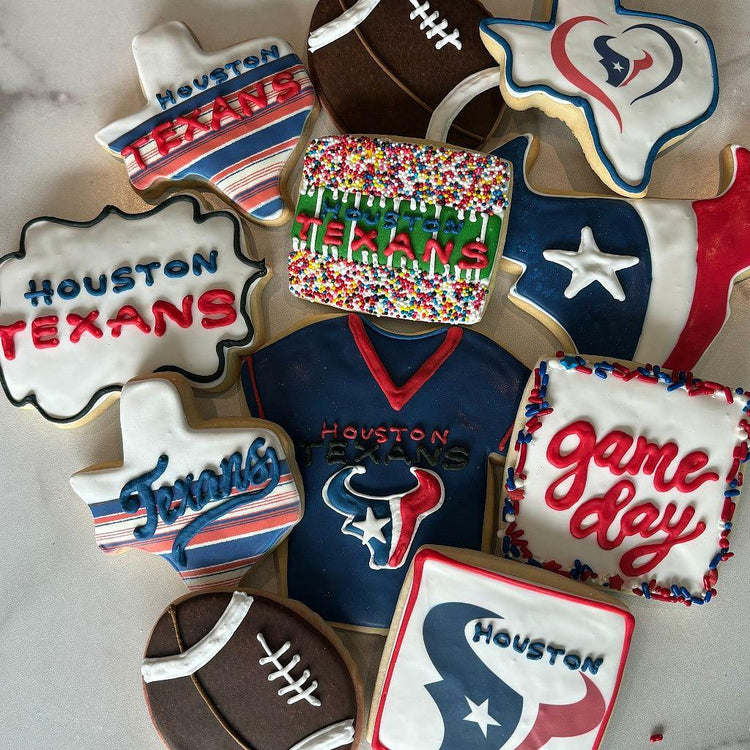 Assorted Houston Texans cookies with team logos and footballs.
