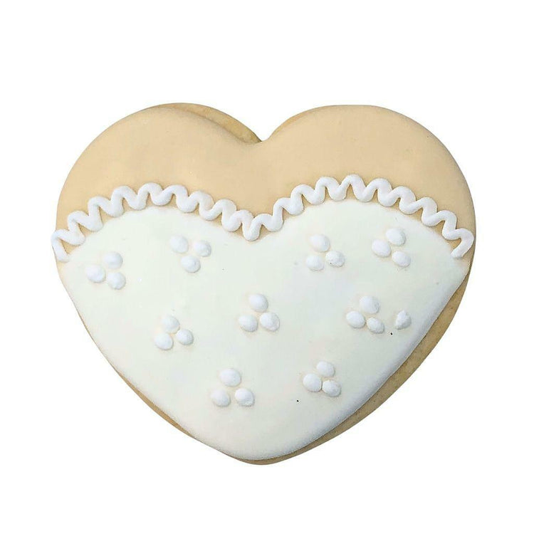 Heart-shaped cookie with white icing and lace detail.
