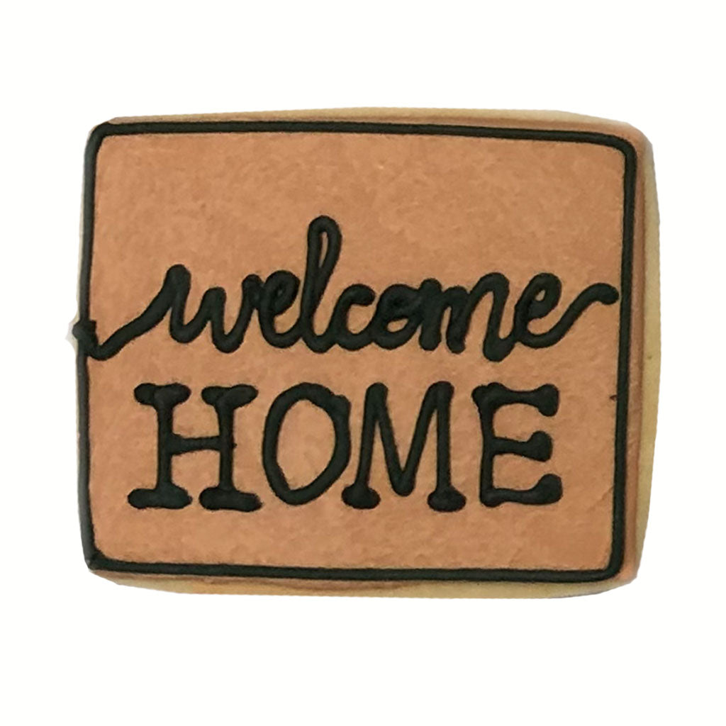 Housewarming gift box cookie shaped like a welcome mat.