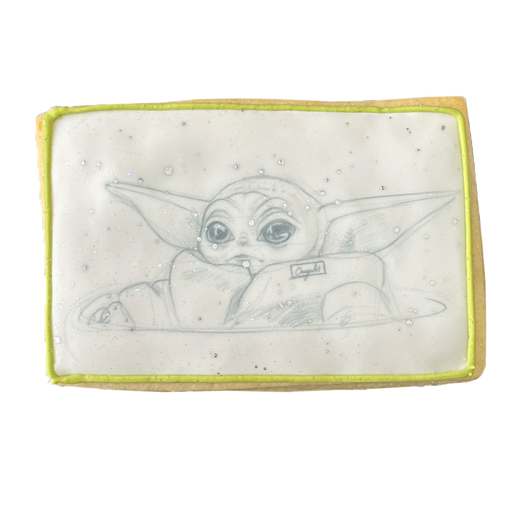 Star Wars cookie with Grogu illustration and green icing border