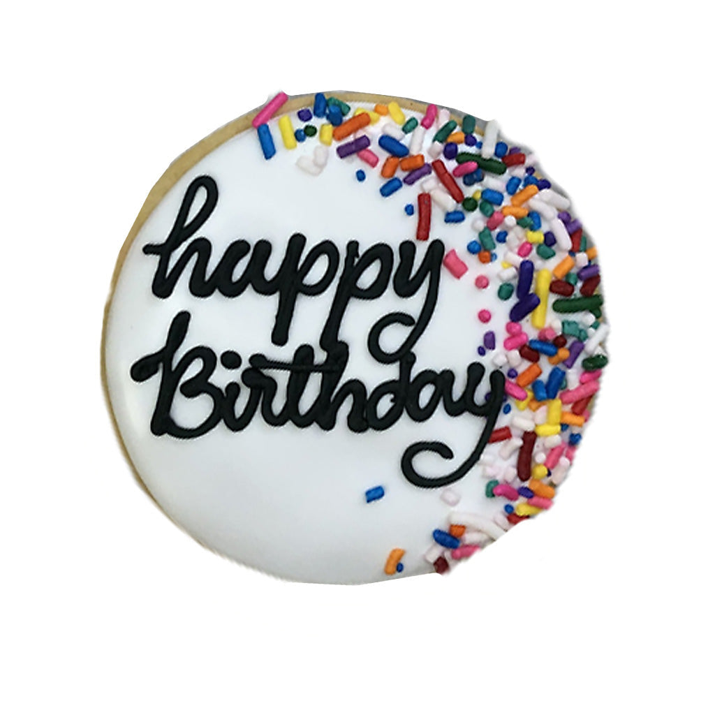 Round birthday plaque cookie with white icing and sprinkles.
