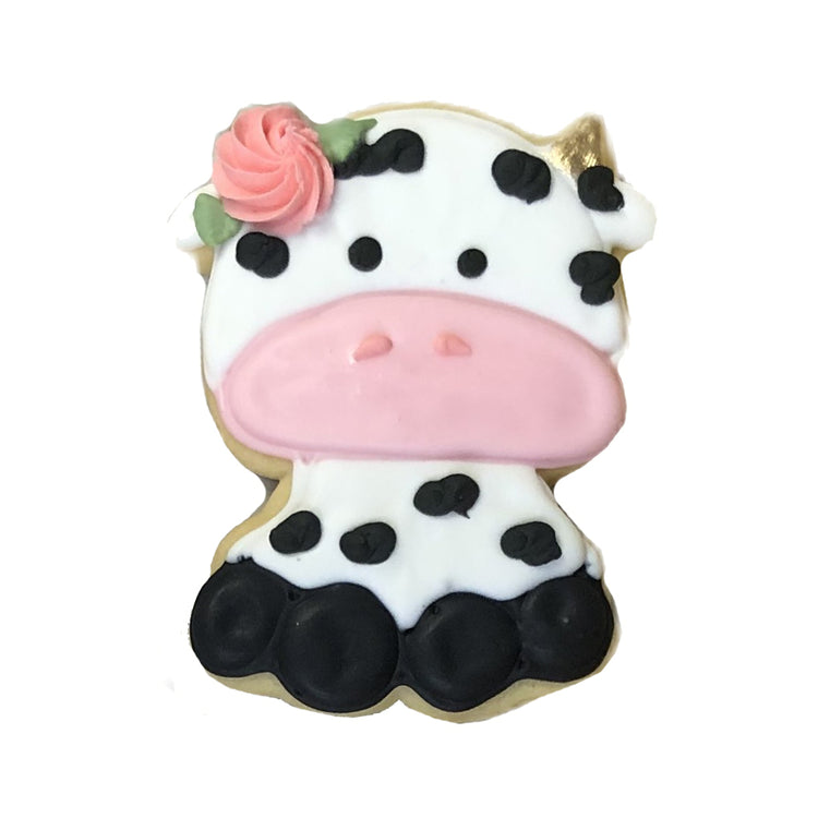 Barnyard Bites cow-shaped cookie with a pink floral accent.