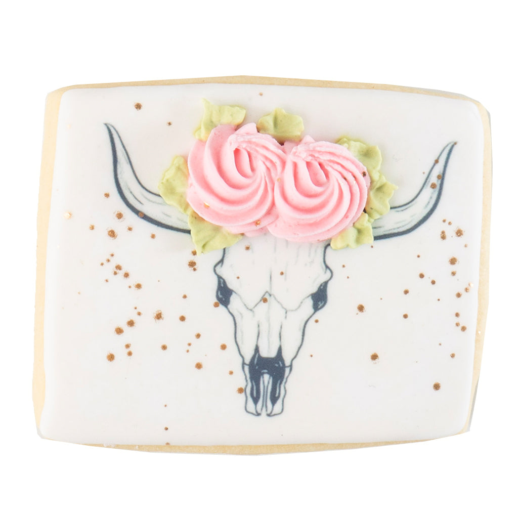 Barnyard Bites cookie with a floral cow skull design