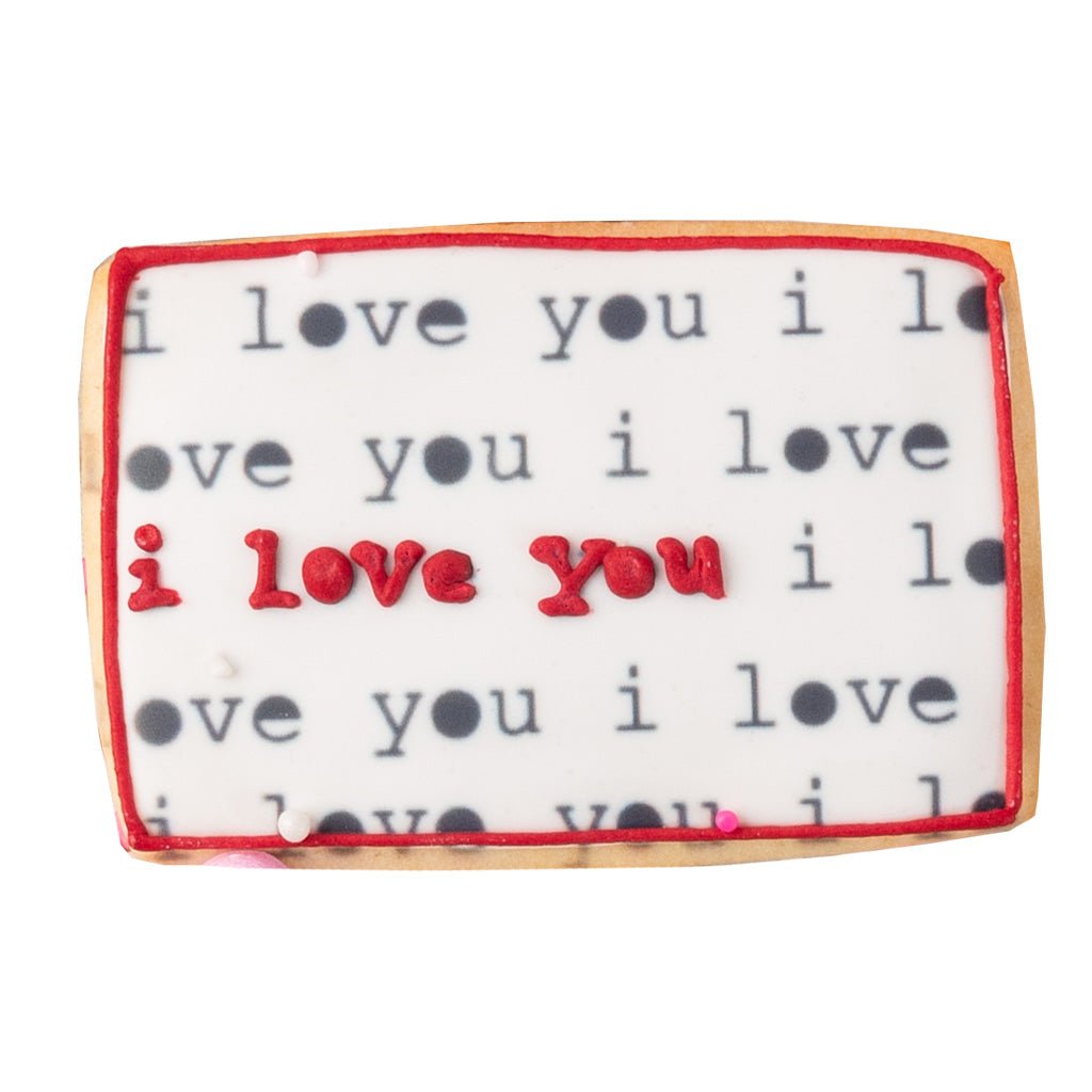 Valentine butter cookie with I love you text and red border.