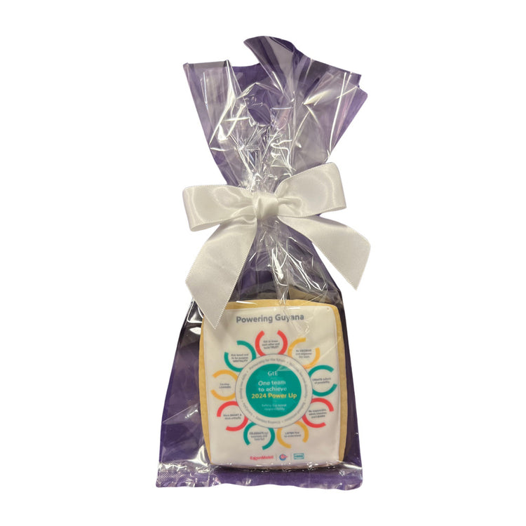 Custom logo cookie in a purple gift bag with a white ribbon.