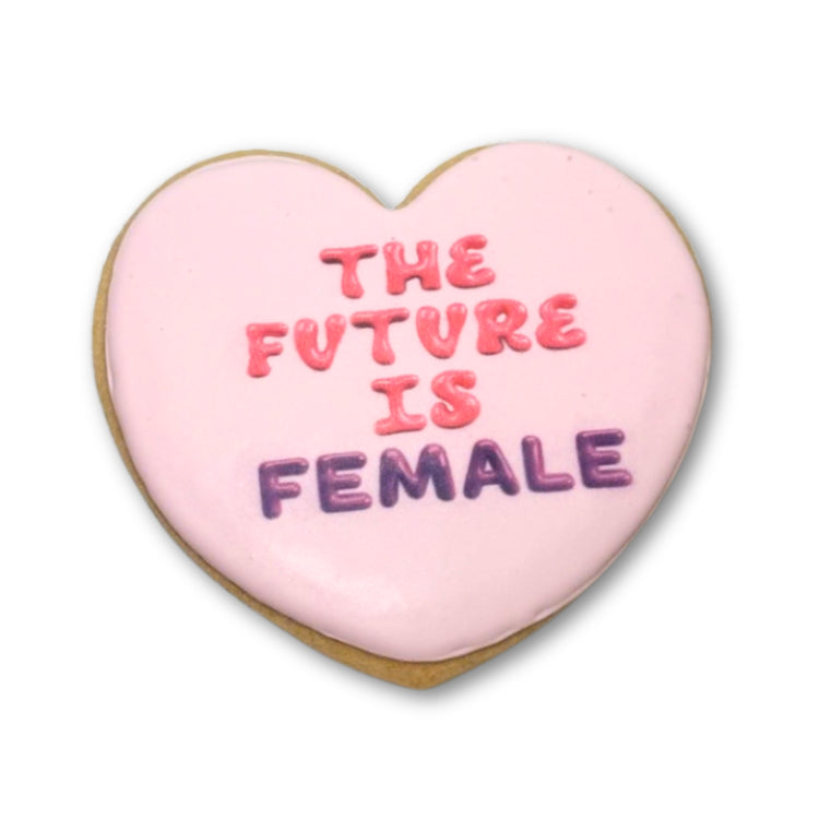 Heart-shaped cookie with pink icing and The Future Is Female text.