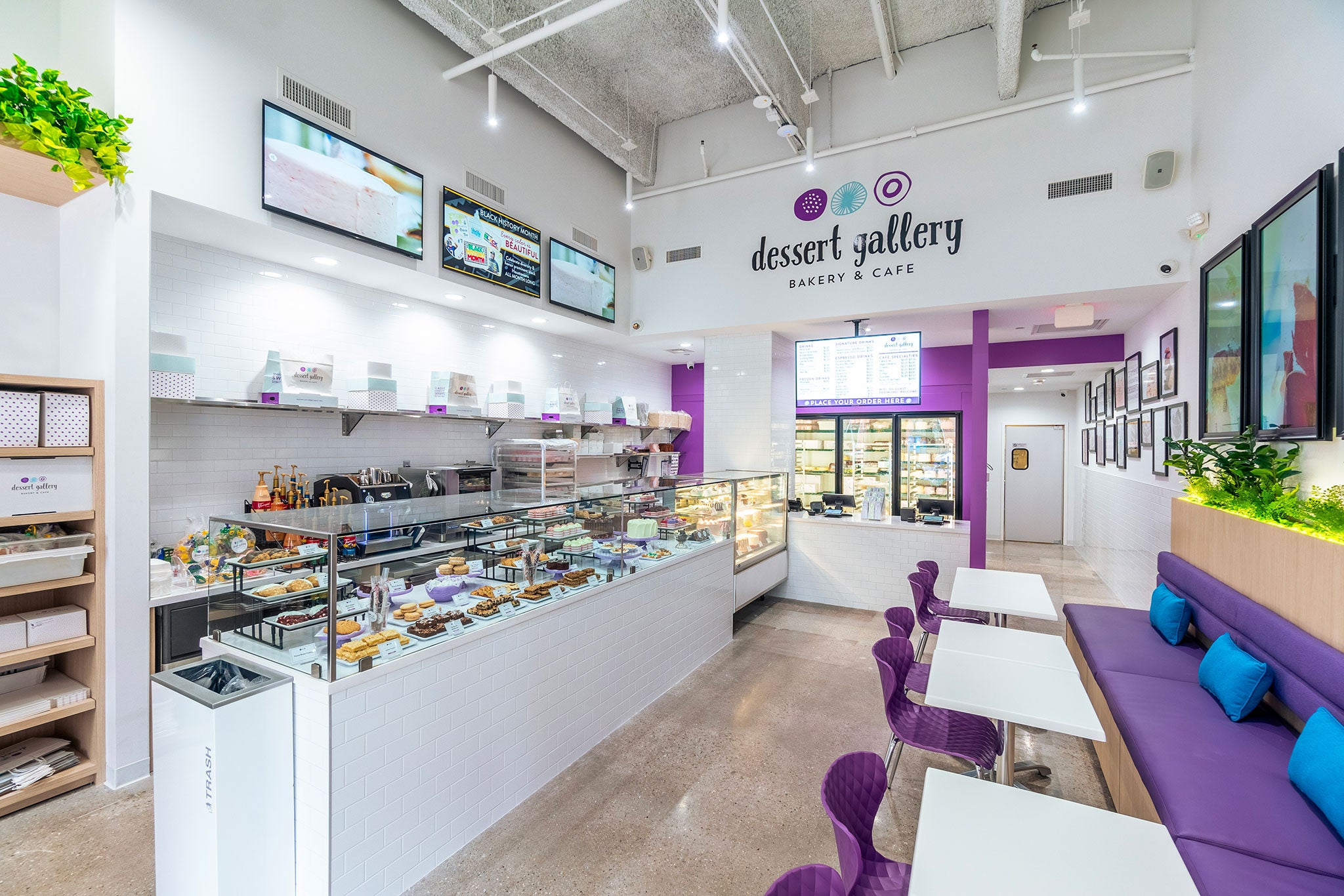 Dessert Gallery bakery interior with purple seating and display cases