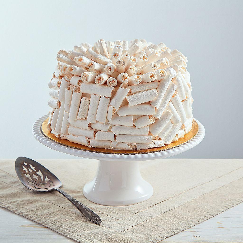6-inch white chocolate Concorde cake covered in meringue.