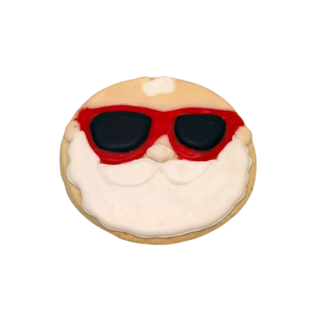Christmas in July cookie shaped like Santa wearing sunglasses.