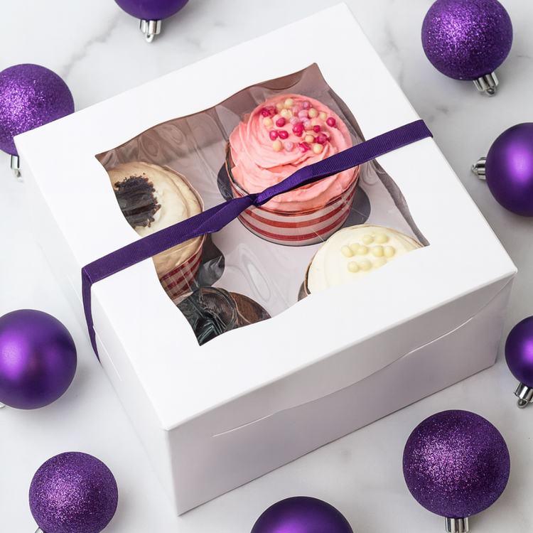 4-pack cupcake gift box with a purple ribbon and ornaments.