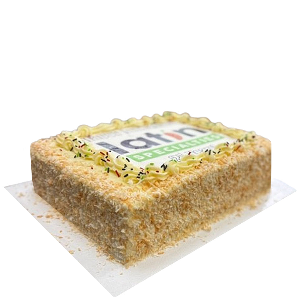 Italian Cream sheet cake with coconut and piped frosting.