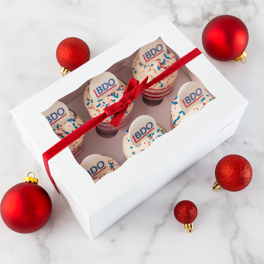 6-pack photo and logo cupcakes in a white box with a red ribbon.